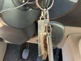 two keys attached to a car ' s door handle