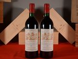 two bottles of wine sitting next to each other on a table