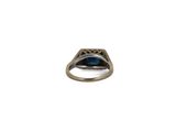 a close up of a ring with a blue stone in it