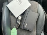 a laptop and a wallet sitting in the back seat of a car