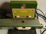 a green machine that is sitting on top of a table
