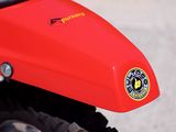 a close up of a red motorcycle parked on the street
