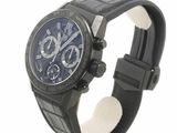 a black watch with a blue face on a display stand