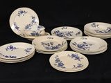 six plates with blue flowers on them on a black background