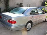 a silver car parked in front of a building