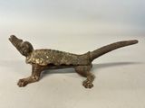 an old bronze figurine of a dog with a collar and tail