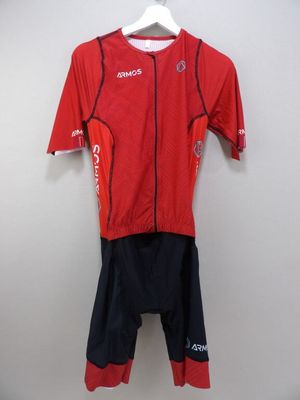 a close up of a red shirt and shorts on a hanger