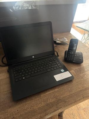 un ordinateur portable et un téléphone posés sur une table en bois
