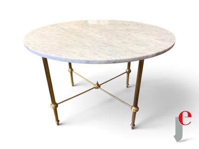 a white marble table with gold legs and a round top