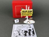 a box with a card and a toy figure in it