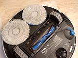 someone is cleaning the floor with a vacuum cleaner and a brush