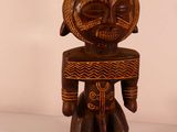 an image of a wooden statue of a man with a hat on