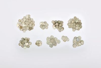 a close up of a bunch of coins on a white surface