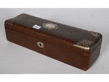 brown leather box with silver trimming and a metal handle