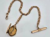 an image of a gold necklace with a watch on it