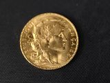 a close up of a gold coin with a woman ' s face on it