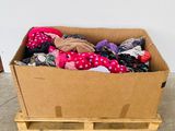 a cardboard box full of clothes on a pallet