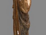 wooden statue of a woman holding a book in her hands