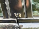 a reflection of a man in the window of a car