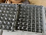 two trays of empty wine glasses sitting on a table