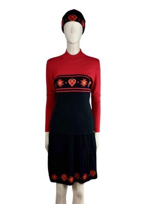 an image of a mannequin wearing a red sweater and black skirt