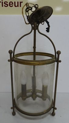 a glass lantern with a bird on top of it