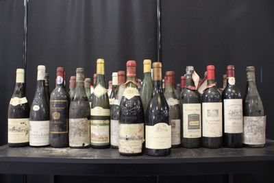 bottles of wine are lined up on a table in front of a black backdrop