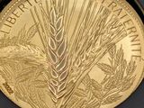 an image of a gold coin with a wheat plant on it