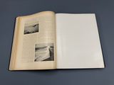 an open book with a picture of a plane flying in the sky