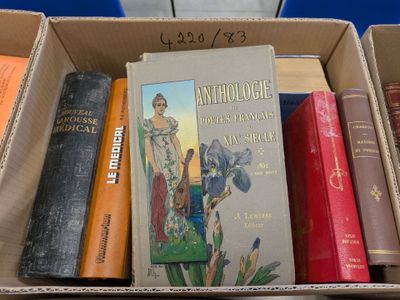 many books in a cardboard box on a table
