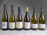 several bottles of wine are lined up in a row on a table