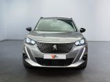 the front view of a silver car parked in a showroom