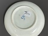 a white plate with a blue and white design on it