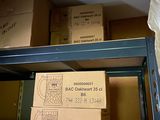 boxes are stacked on a shelf in a storage room