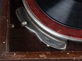a close up of a record player on a wooden table