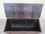 a wooden box with a lid open on a cement floor