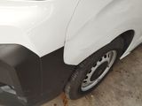 a close up of a white van with a black bumper