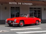 a red car that is parked in front of a hotel