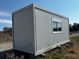 a small white building sitting on the side of the road