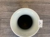 a cup of coffee on a table next to a pair of shoes