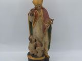 an old statue of a man with a dog on a pedestal