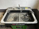 a dirty sink in the corner of a room