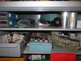 a metal shelf with many different items on it
