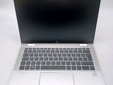 an open laptop computer sitting on top of a white table