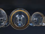 several empty wine glasses are lined up on a black surface