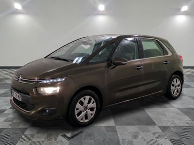 the brown citrole is parked on a checkered tile floor