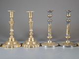 six candlesticks are lined up in a row on a table