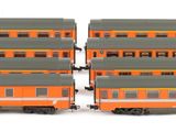 four toy trains are lined up on a white surface