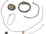 an assortment of jewelry including a necklace, bracelet, and broochet