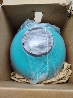 a blue ball in a cardboard box that is wrapped in plastic